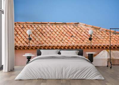 Roof tiles over home on a bright sunny afternoon with sky Wall mural